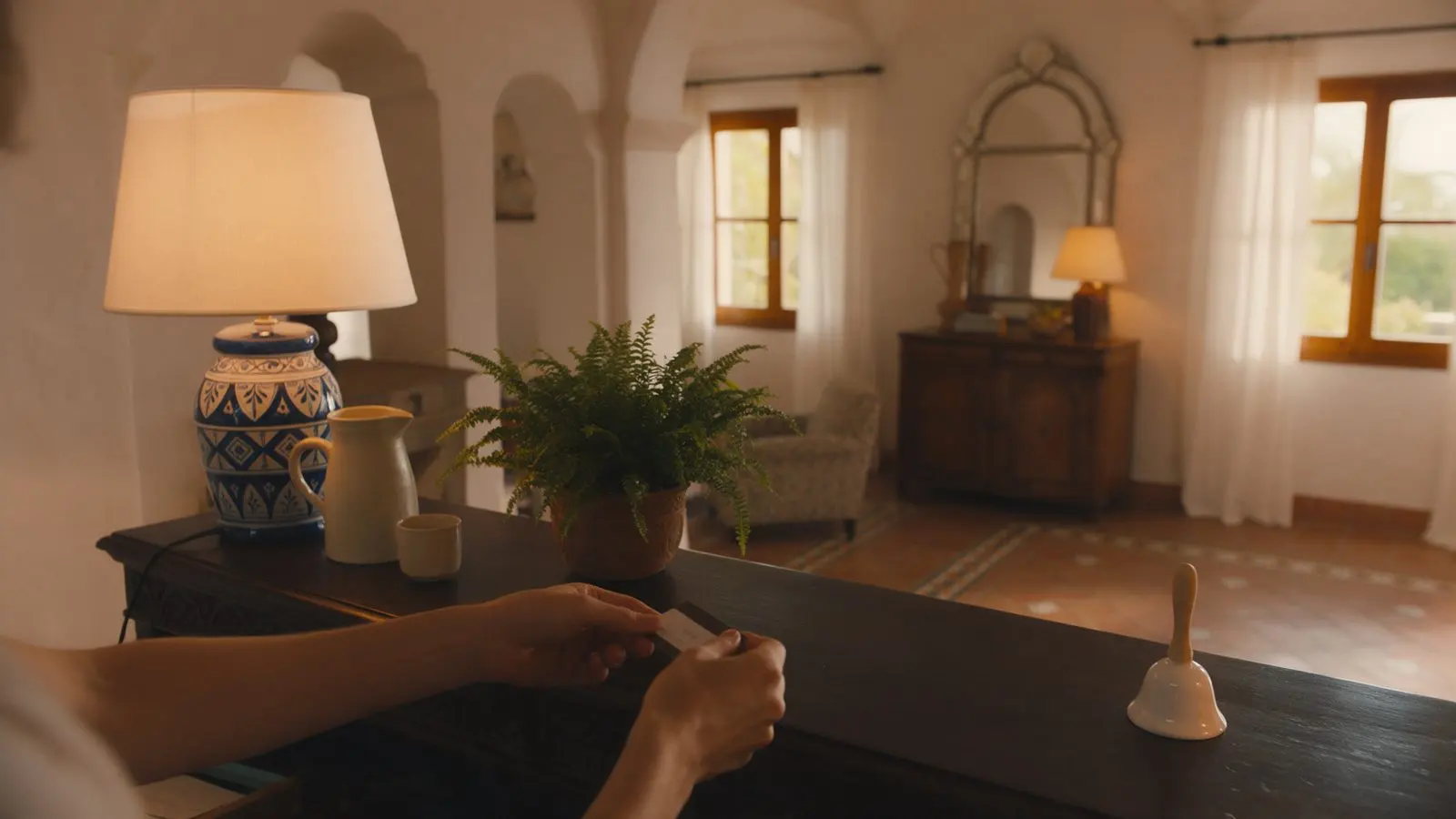 A guest's hands at a hotel reception desk at checkout.